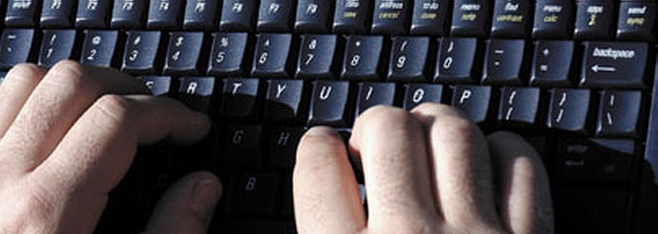 WriterForHigher.com centerpiece image for its home page, a very close-up shot of a real navy-colored laptop keyboard with two caucasian hands using it.
